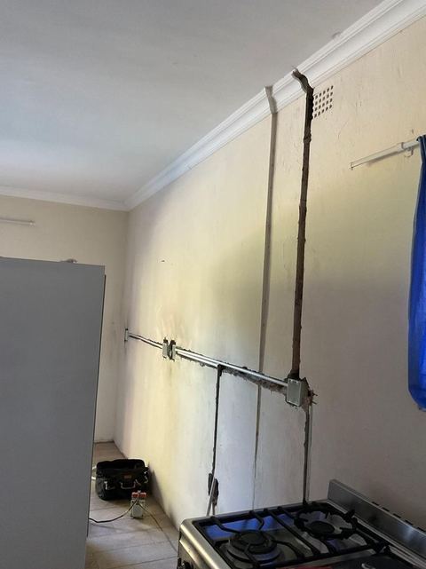 Neat surface conduit running along a wall and ceiling